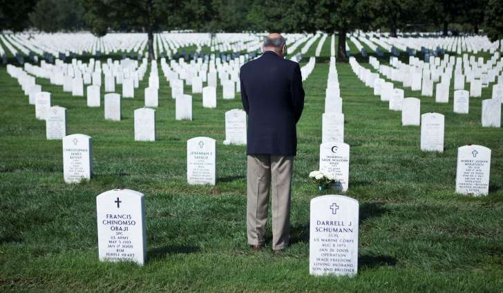 Khizr Khan pauses at the grave of his son, Army Capt. Humayun Saqib Muazzam Khan, who died while serving in Iraq, at Arlington National Cemetery. 