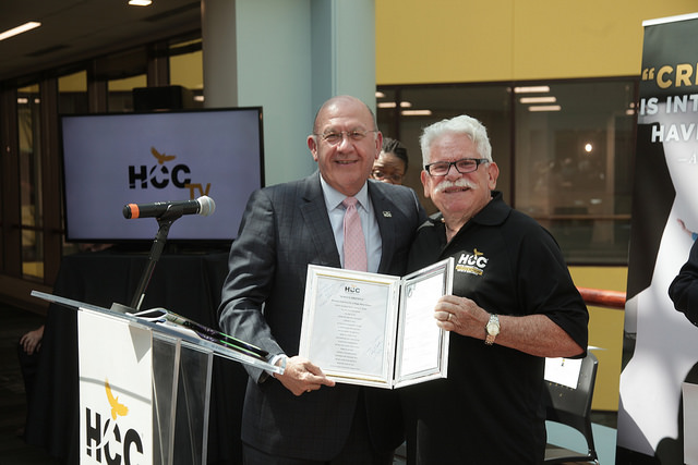 Photo: Dr. Aubrey Tucker (right), coordinator of the HCC Commercial Music program, transferred the copyright of the HCC Alma Mater, "Always Grateful", to Dr. Cesar Maldonado, HCC chancellor during the June Grand Opening of the HCC Media Arts & Technology Center of Excellence.