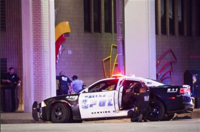 Dallas Police shield bystanders during a Black Live Matter rally in downtown Dallas on Thursday, July 7, 2016. Multiple media outlets report that shots were fired Thursday night during a Dallas protest over two recent fatal police shootings of black men. 