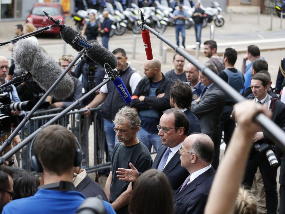 French President Francois Hollande speaks to the press as he leaves the Saint-Etienne-du-Rouvray's city hall following a hostage-taking at a church of the town on July 26, 2016 that left the priest dead. 