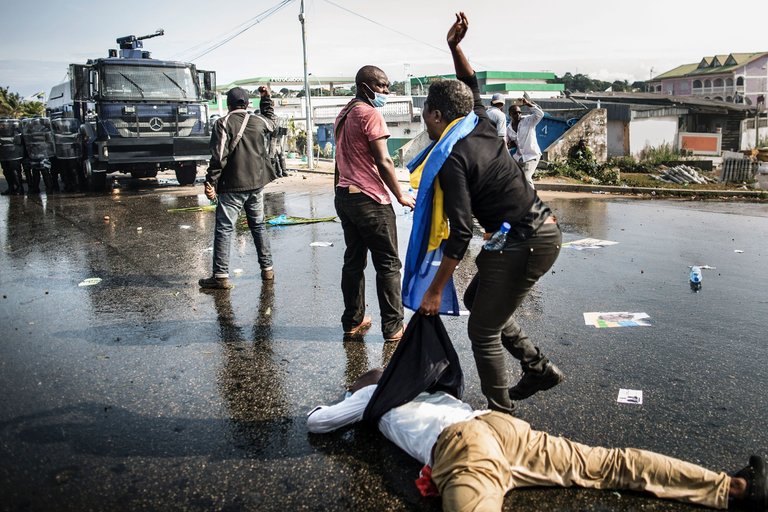 A supporter of the opposition leader Jean Ping lay wounded in Libreville on Wednesday during clashes with riot police.