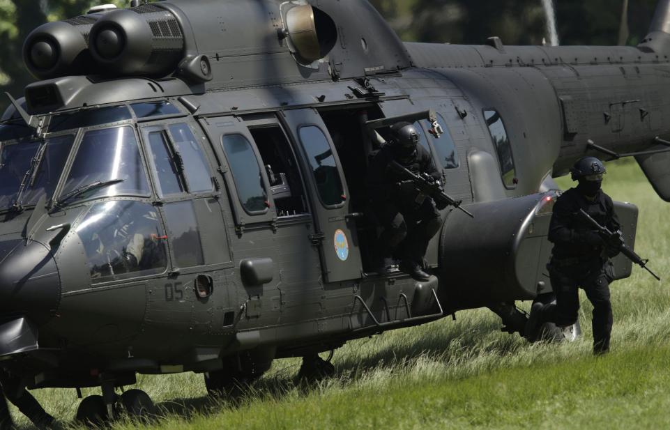 Brazilian Army soldiers leave a military helicopter as they take part in an exercise ahead the 2016 Rio Olympics in Rio de Janeiro, Brazil, April 6, 2016.