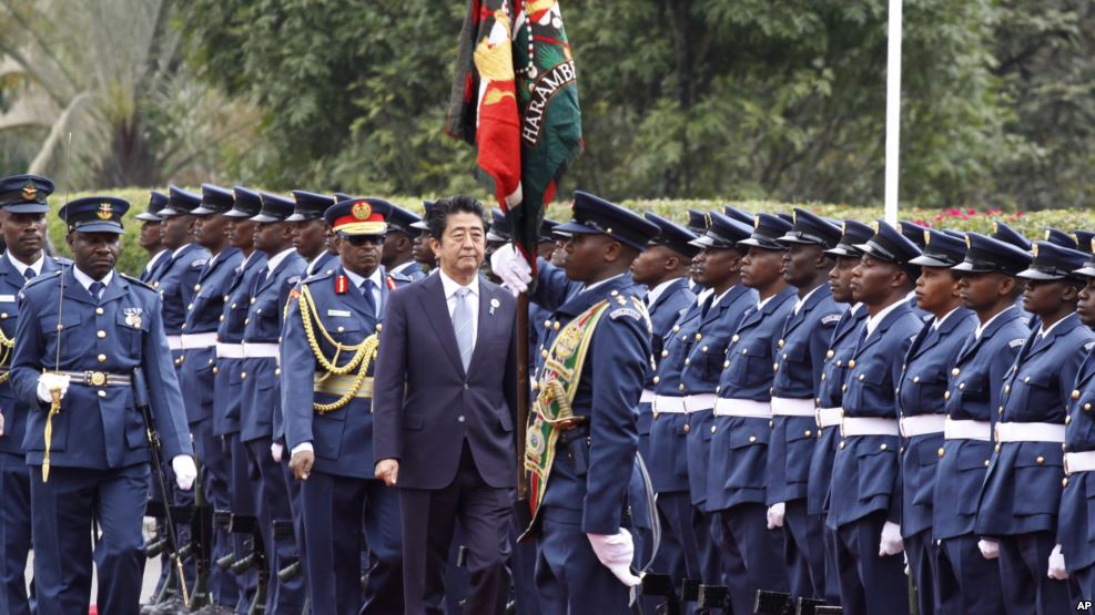Japan's Prime Minister Shinzo Abe inspects a military honor guard in Nairobi, Kenya, where he's visiting as part of an international development conference, Aug. 26, 2016.