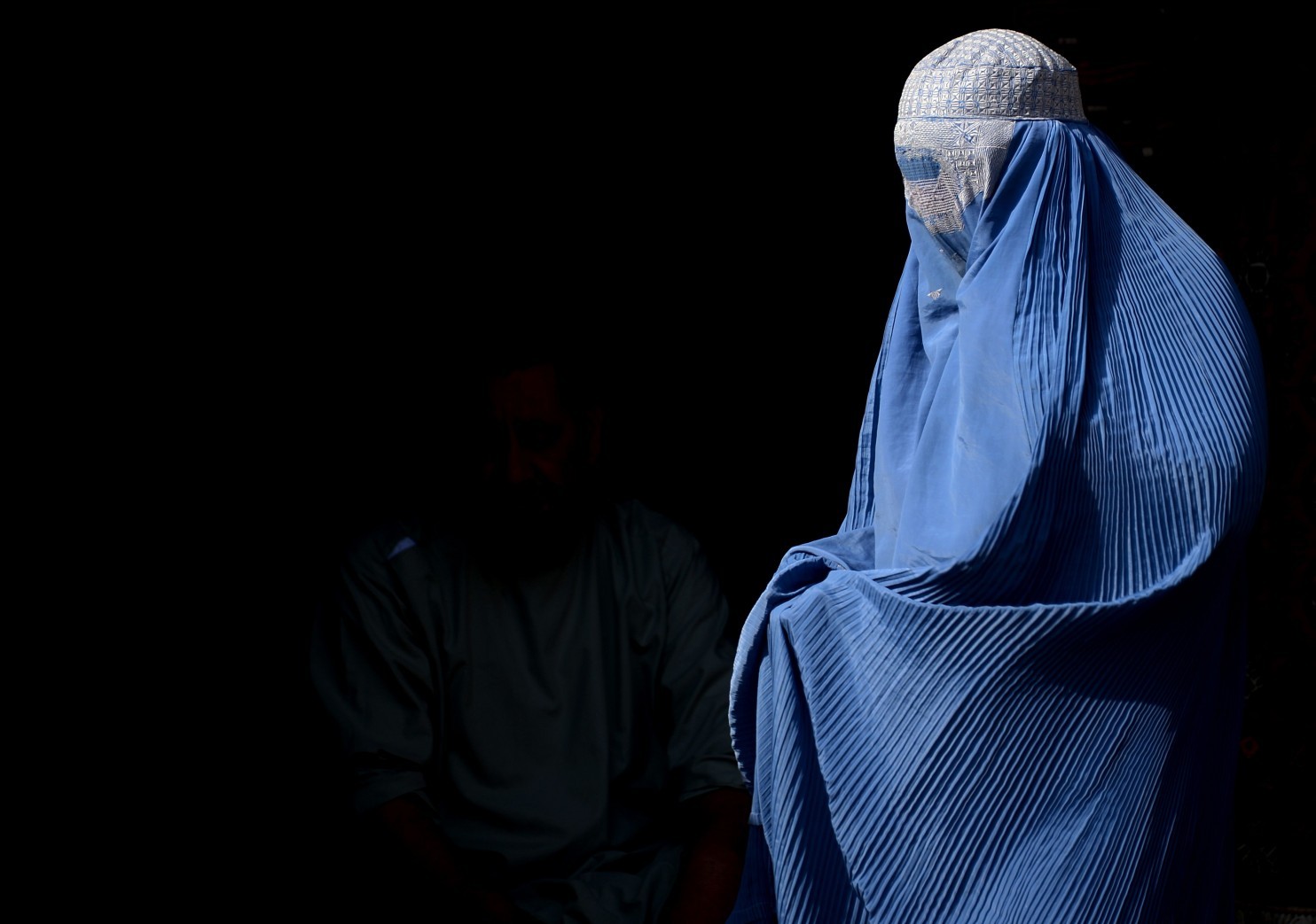 A burqa-clad Afghan woman walks along a road in Herat. / AFP PHOTO / AREF KARIMI/AFP/Getty Images (Aref Karimi/AFP/Getty Images) 