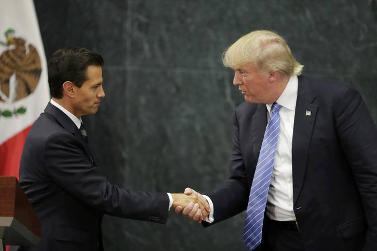 Mexico's President Enrique Peña Nieto and U.S. Republican presidential nominee Donald Trump shake hands at a news conference at Los Pinos in Mexico City on Wednesday. PHOTO: HENRY ROMERO/REUTERS
