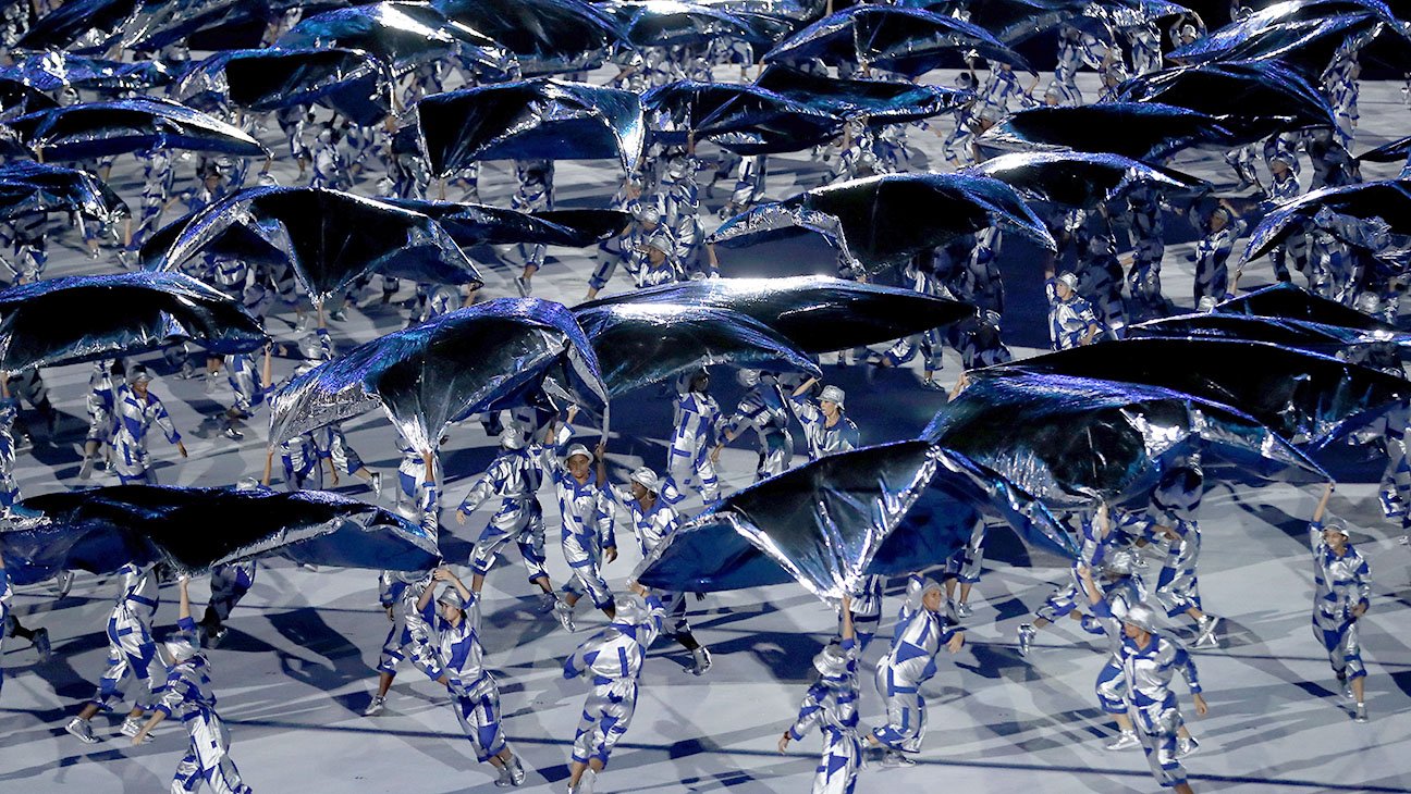 Performers dance during a light show at the opening ceremony. 