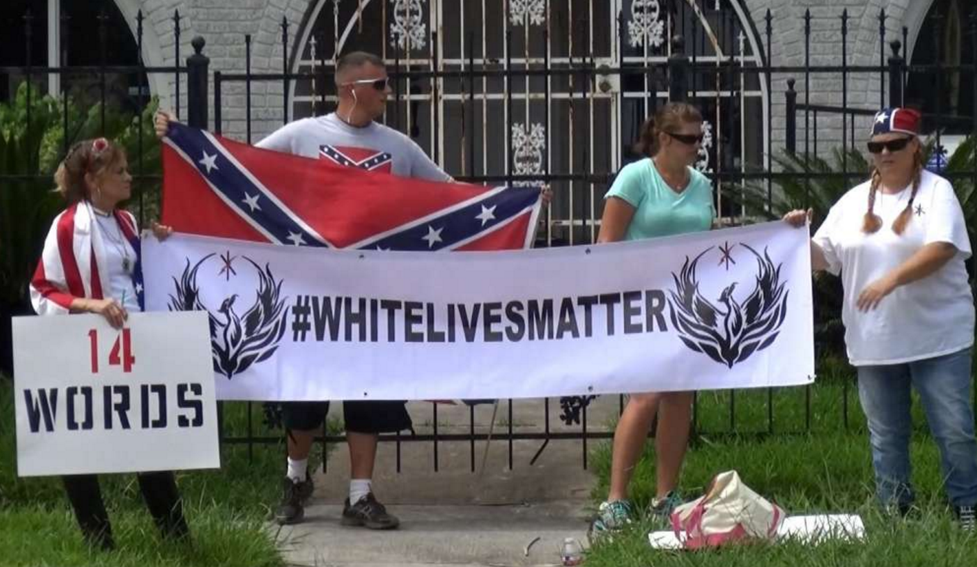 The organizer of Sunday's protest outside an NAACP office said the group is not racist, but their clothing and signs may send a different message. Video provided by Newsy Newslook