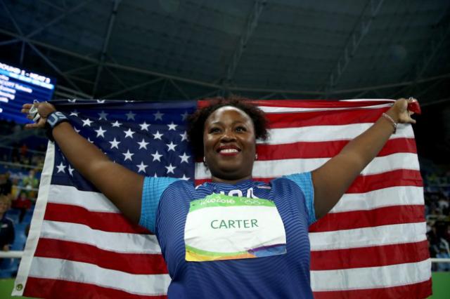 Michelle Carter carries an American flag after winning gold in the shot put at the 2016 Olympics. (Getty)