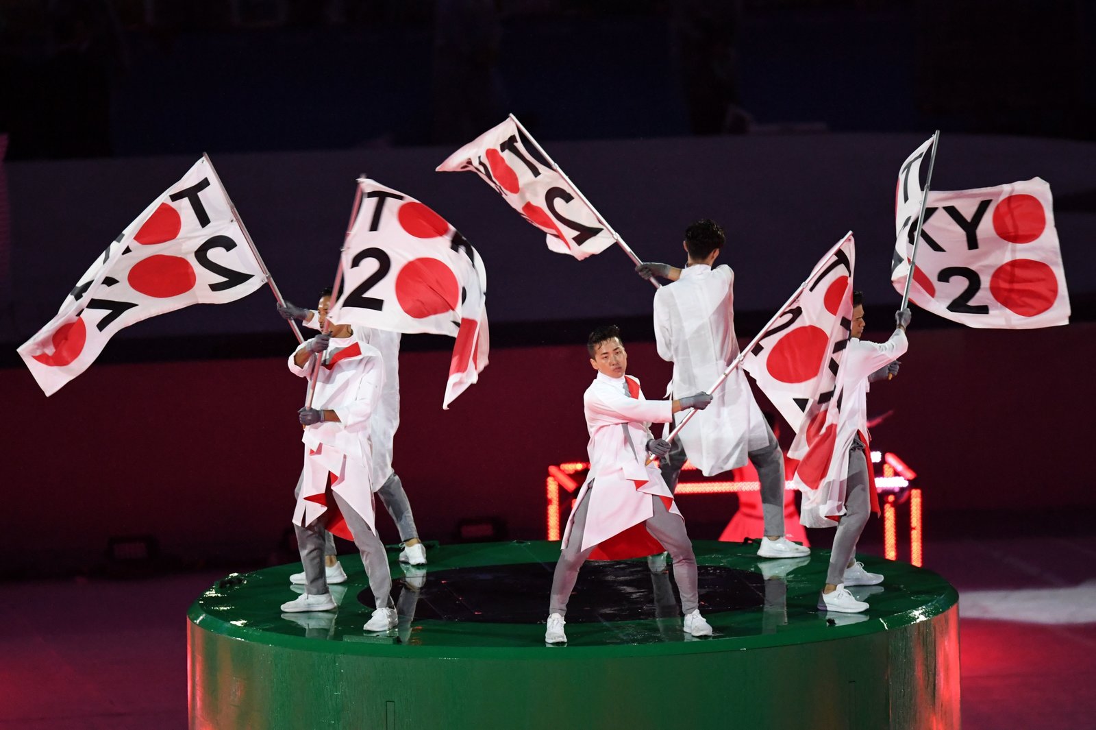 Dancers wave flags ushering in excitement for the 2020 Summer Olympics which will be held in Tokyo.