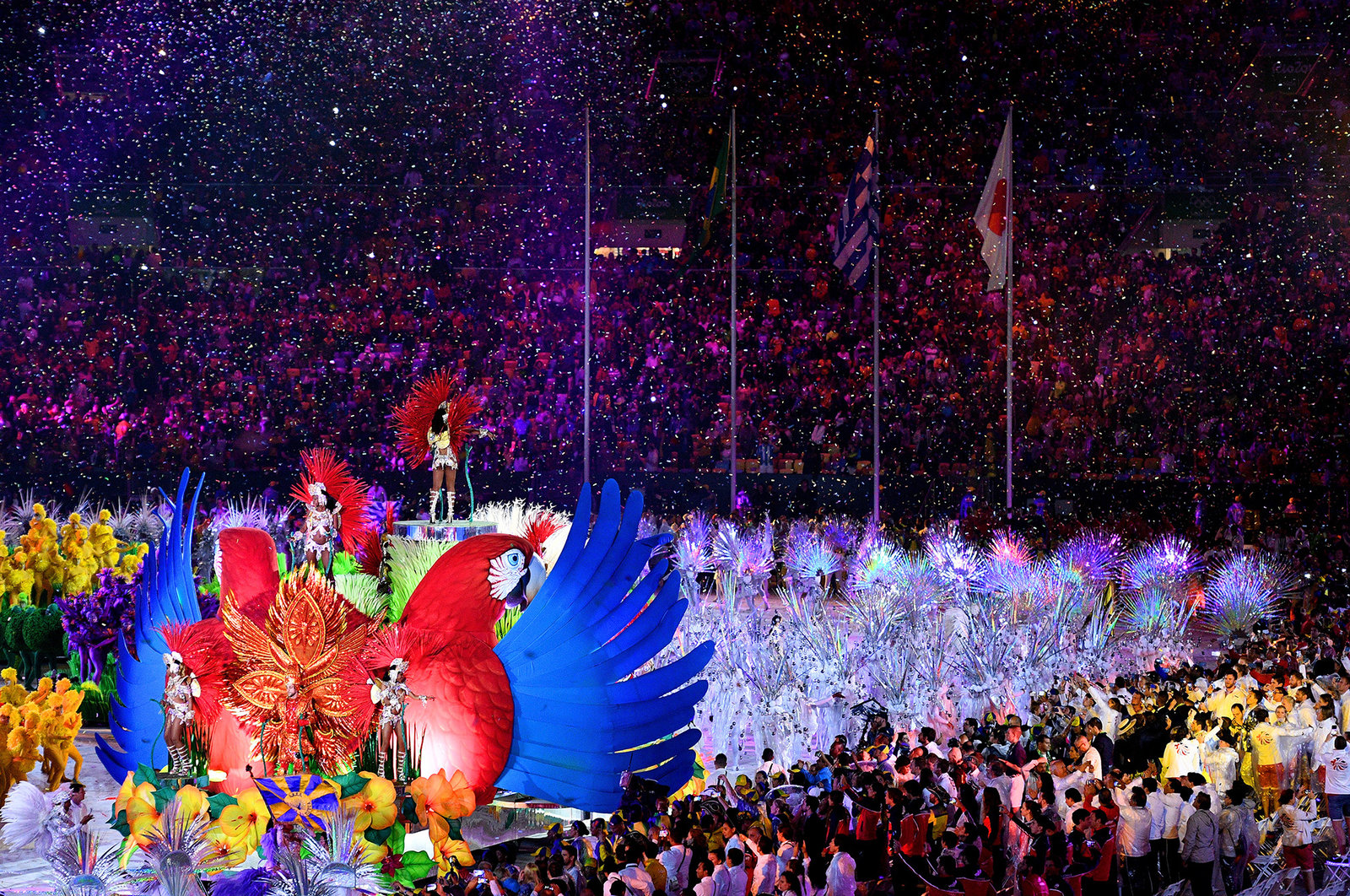 Confetti falls as singers and dancers perform during the closing ceremony on Sunday. 