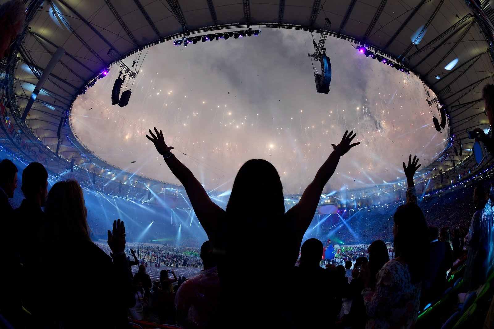 Spectators dance as fireworks light up the sky during the closing ceremony of the Rio 2016 Olympic Games on Sunday. 