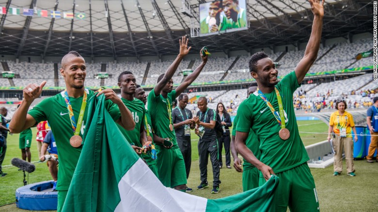 Happier times: Nigeria's players William Ekong (L) and John Obi Mikel (R) celebrate with bronze medals at the Rio 2016 Olympics. A Japanese fan gifted the cash-strapped team $390,000 after the match. 
