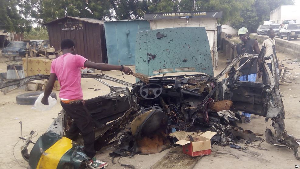 People gather at the scene of a car bomb explosion in Maiduguri, Nigeria, Oct. 12, 2016.