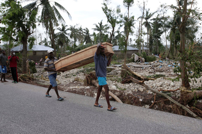 Carrying a coffin on Thursday in Cavaillon. In one part of the country’s southern peninsula, where Cavaillon is situated, nearly 30,000 homes were destroyed and 150 lives lost, officials said. Credit Andres Martinez Casares/Reuters 