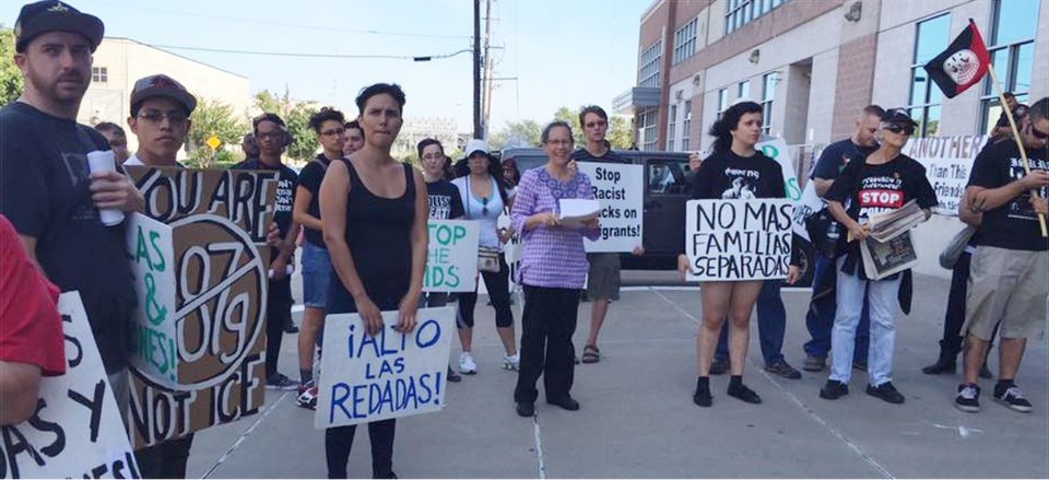 Protesters gather outside the Harris County Sheriff's Office Saturday to protest raids and deportation in the Harris County.