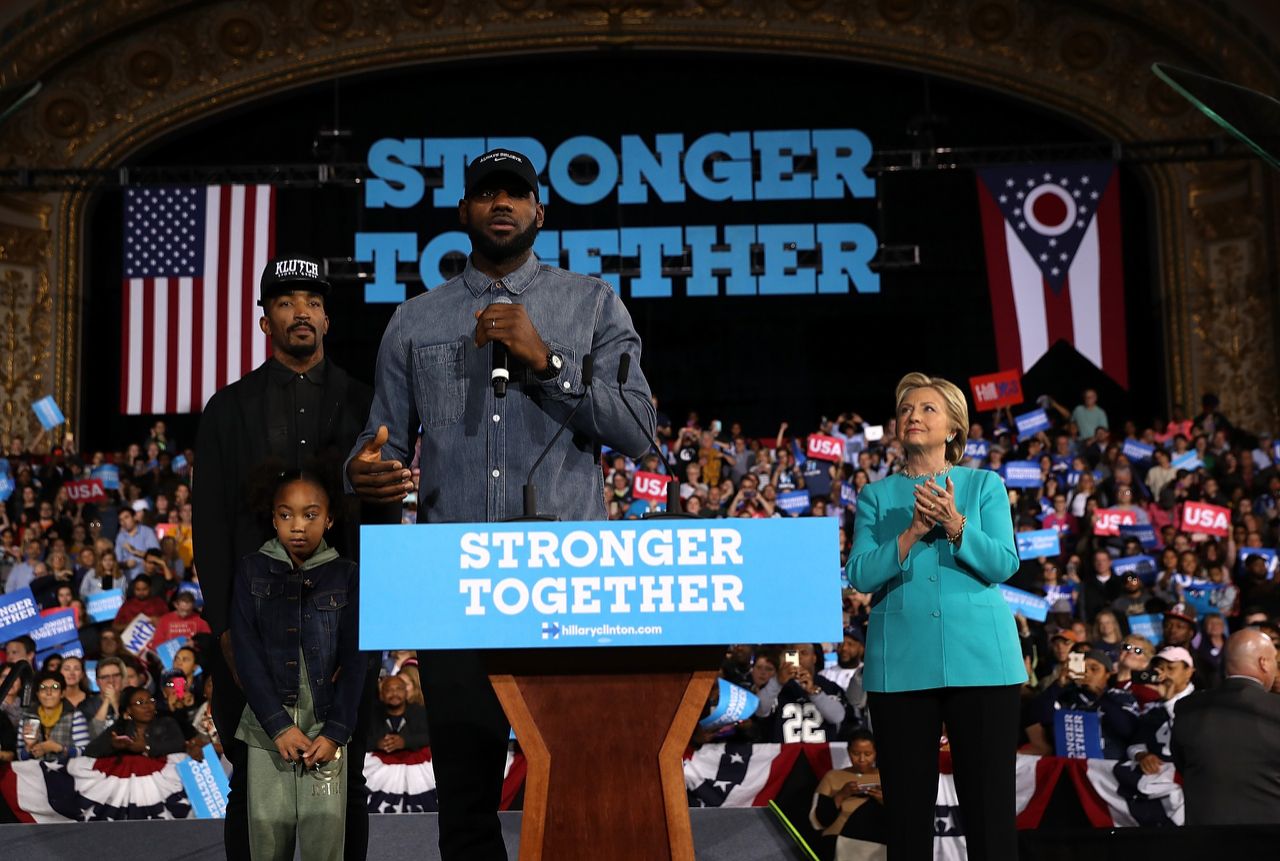 LeBron James (C) speaks as Democratic presidential nominee former Secretary of State Hillary Clinton (R) and J.R. Smith (L) look on during a campaign rally at the Cleveland Public Auditorium on November 6, 2016 in Cleveland, Ohio. With two days to go until election day, Hillary Clinton is campaigning in Florida and Pennsylvania. (Photo by Justin Sullivan/Getty Images)  