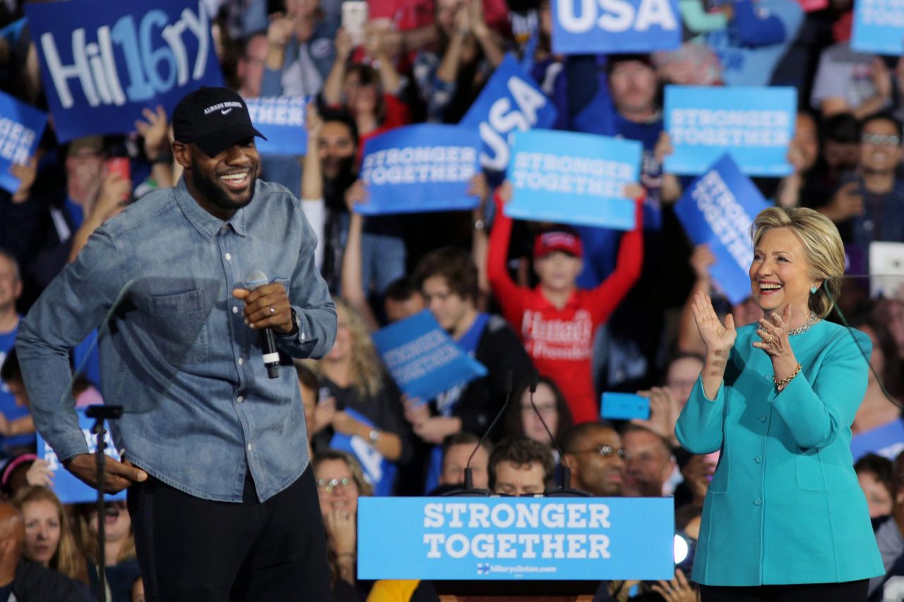 LeBron James (C) speaks as Democratic presidential nominee former Secretary of State Hillary Clinton (R) and J.R. Smith (L) look on during a campaign rally at the Cleveland Public Auditorium on November 6, 2016 in Cleveland, Ohio. With two days to go until election day, Hillary Clinton is campaigning in Florida and Pennsylvania. (Photo by Justin  