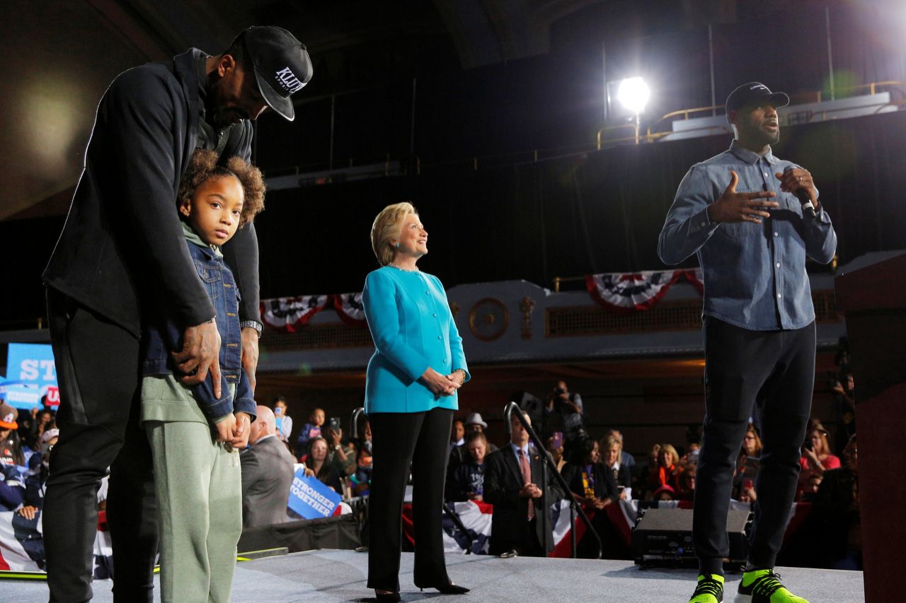 U.S. Democratic presidential nominee Hillary Clinton is joined by the Cleveland Cavaliers LeBron James (R) and J.R. Smith (L), with his daughter Demi, at a campaign rally in Cleveland, Ohio, U.S. November 6, 2016. REUTERS/Brian Snyder  