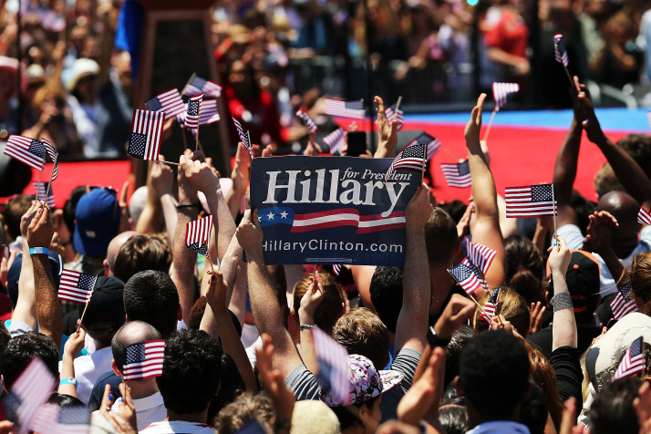 NEW YORK, NY - JUNE 13:  People cheer as Democratic Presidential candidate Hillary Clinton speaks at her official kickoff rally at the Four Freedoms Park on Roosevelt Island in Manhattan on June 13, 2015 in New York City. The long awaited speech at a historical location associated with the values Franklin D. Roosevelt outlined in his 1941 State of the Union address, is the Democratic the candidate's attempt to define the issues of her campaign to become the first female president of the United States.  (Photo by Spencer Platt/Getty Images)