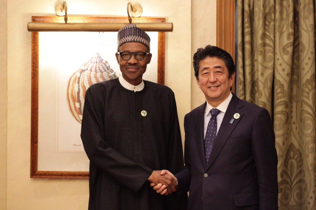 File: President Buhari in a handshake with Shinzo Abe, the Japanese Prime Minister