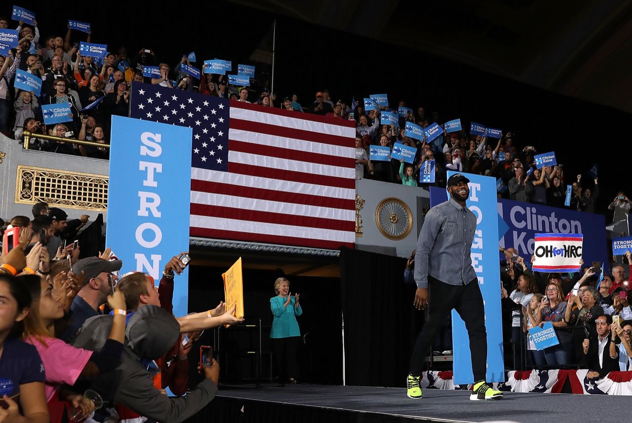 LeBron James (R) and Democratic presidential nominee former Secretary of State Hillary Clinton (L) greet supporters during a campaign rally at the Cleveland Public Auditorium on November 6, 2016 in Cleveland, Ohio. With two days to go until election day, Hillary Clinton is campaigning in Florida and Pennsylvania. (Photo by Justin Sullivan/Getty Images)  