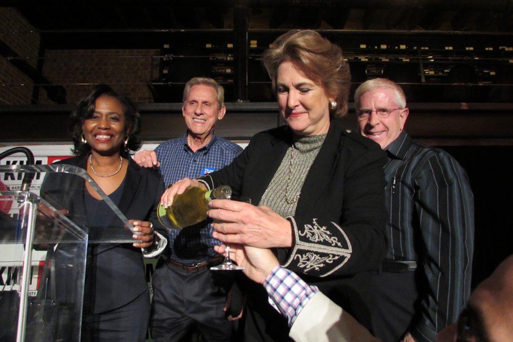 Kim Ogg making a champagne toast with supporters at her election night party at the Heights, Houston.